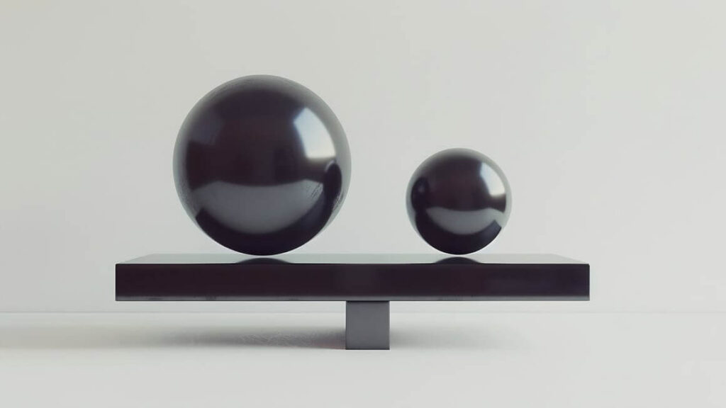 two dark grey balls hovering over a dark grey table