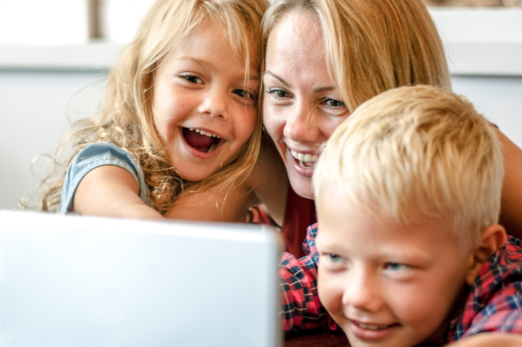 image of family looking at a screen together